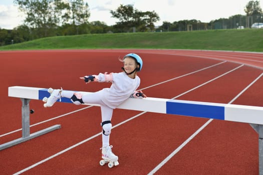 Girl in vintage white roller skates and a helmet at the stadium