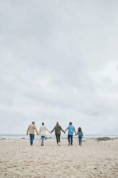 Holiday, family and walking beach in summer vacation, travel and freedom in South Africa. Love, freedom and care grandparents, parents and kid relax, bond and enjoy winter ocean trip together.