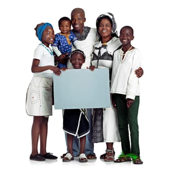 We believe in this message. Studio shot of a traditional african family holding a blank board, isolated on white