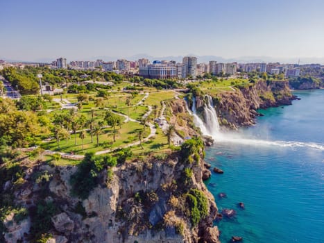 Lower Duden Falls drop off a rocky cliff falling from about 40 m into the Mediterranean Sea in amazing water clouds. Tourism and travel destination photo in Antalya, Turkey. Turkiye