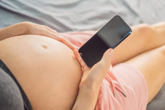 Pregnancy mockup app. Mobile pregnancy online maternity application. Pregnant mother using phone mock up. Pregnancy, medicine, pharmaceutics, health care and people concept.