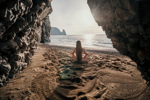 Middle aged well looking woman with black hair doing Pilates with the ring on the yoga mat near the sea on the pebble beach. Female fitness yoga concept. Healthy lifestyle, harmony and meditation.