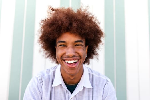 Headshot of happy African American Black young man smiling looking at camera. Summertime. Portrait.