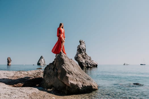 Woman travel sea. Happy tourist taking picture outdoors for memories. Woman traveler looks at the edge of the cliff on the sea bay of mountains, sharing travel adventure journey.