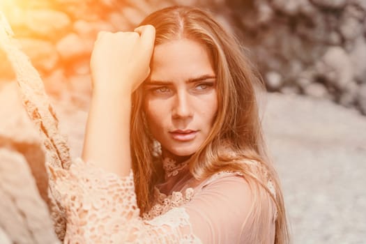 Woman travel sea. Young Happy woman in a long red dress posing on a beach near the sea on background of volcanic rocks, like in Iceland, sharing travel adventure journey