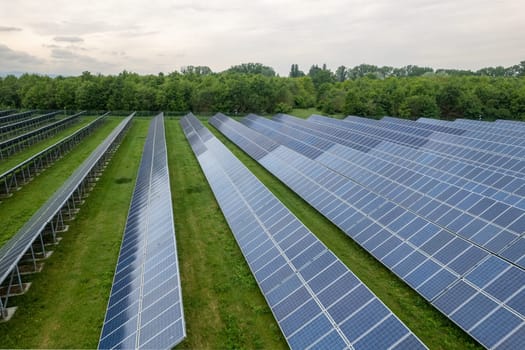 Renewable energy. Aerial shot drones fly over a photovoltaic power station. Group pf solar panels looking the sun for energy production.