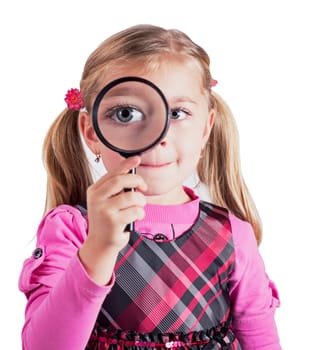 Beautiful little girl looking through a magnifying glass