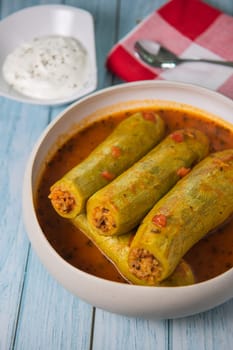 Recipe of stuffed courgette with tomato sauce, Lebanese style, Kouca Mehchi bi Banadoura, with Greek yogurt. High quality photo