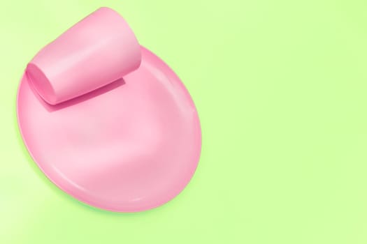 put, lay, or stand something in a specified place or position. Pink plastic camping spoons and forks isolated on white.
