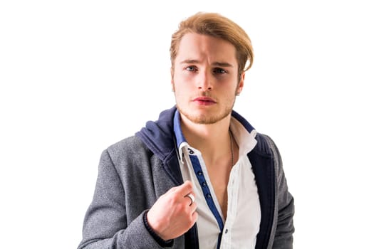 Handsome young man with aggressive expression of challenge, isolated on white background