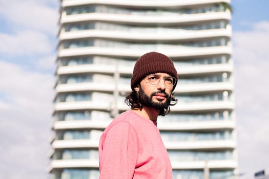 stylish young man walking in the morning at city, concept of street style and urban lifestyle, copy space for text