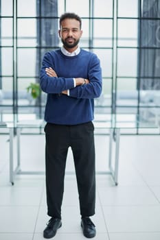 Confidence and charisma. Cheerful young African man keeping arms crossed and looking at camera