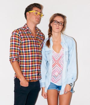 Crazy nerd couple at party, glasses and funny face with gen z fashion with university youth culture. Goofy woman, man and celebration at fun college, silly hipster people on white wall background