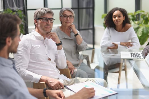 discussion of business people in the office sitting at the table.