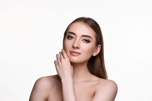 Beautiful young woman touching cheeks and enjoy perfect skin on white background