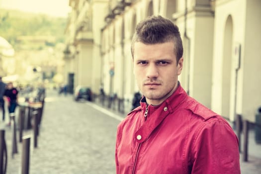 One handsome young man in urban setting in European city