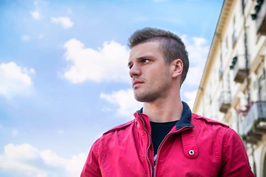 One handsome young man in urban setting in European city