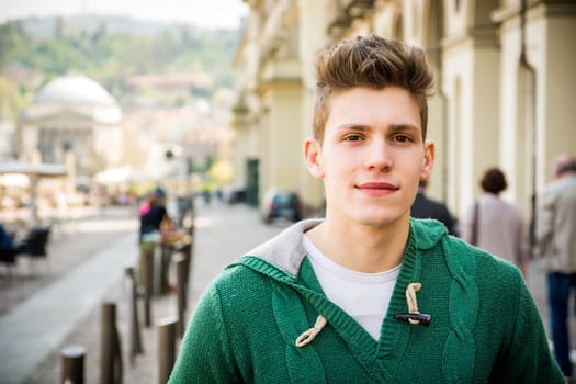 One handsome young man in urban setting in European city