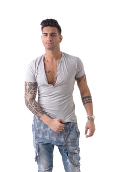 Young man wearing denim overalls and white t-shirt isolated in studio shot against white