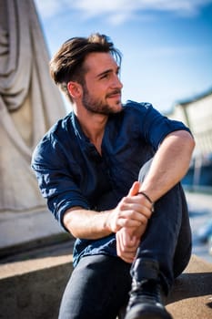 One handsome young man in urban setting in European city, Turin in Italy
