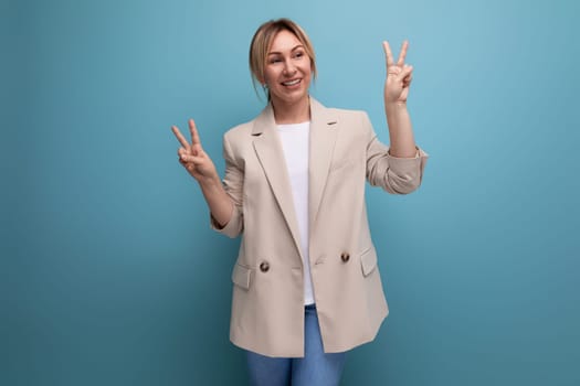 close-up portrait of a positive kind blonde young woman in a stylish elegant look in the studio with copy space.