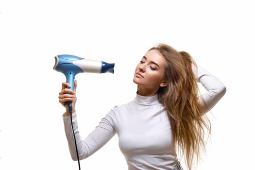 attractive cheerful lady drying long hair isolated on white background