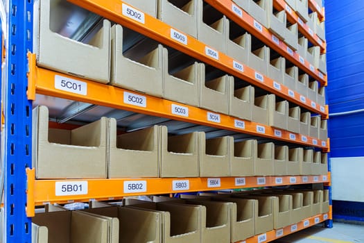 Boxes on racks in a warehouse of goods close-up. High quality photo