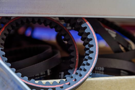 Toothed drive belt for a compressor in a box in stock. Close-up. High quality photo