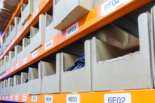 Boxes on racks in a warehouse of goods close-up. High quality photo
