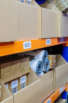 Boxes on racks in a warehouse of goods close-up. High quality photo