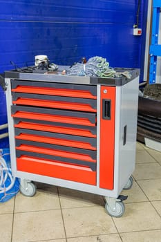 Tiered toolbox with tools in auto repair shop. High quality photo