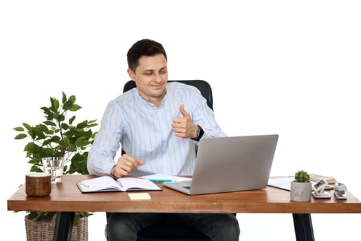 happy friendly businessman talking at laptop webcam, sitting on chair at desk, using laptop