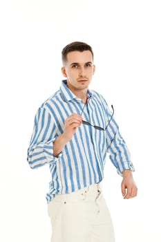 handsome young man in sunglasses and blue striped shirt isolated on white background. Summer fashion