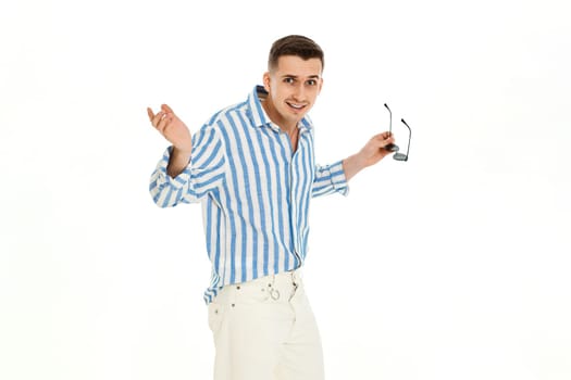 handsome young man in sunglasses and blue striped shirt isolated on white background. Summer fashion