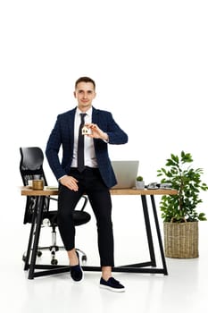Successful caucasian businessman holding toy house in the office. real estate insurance