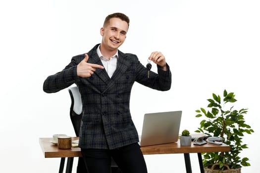 Successful caucasian businessman pointing finger at keys . Car dealerships offer car . Car insurance. copy space
