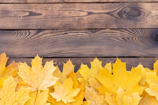 Autumn leaves frame on one down side wooden background top view Fall Border yellow and Orange Leaves vintage wood table Copy space. Mock up for your design. Display for product or text