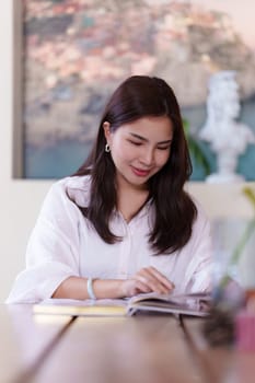 Attractive Asian woman resting comfortable living room and reading book, Relax, Sofa, Lifestyle.