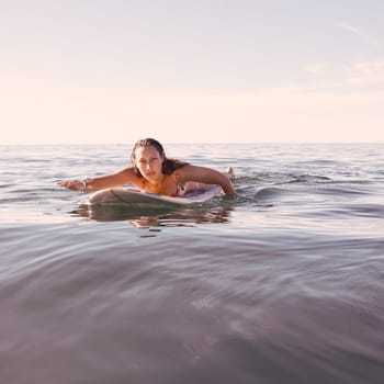 Surfing, woman and portrait in waves, sea and ocean for summer adventure, freedom and sky mockup in Australia. Female surfer, board and swimming in water, beach and relax for tropical holiday travel.