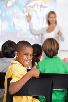 Black child, portrait and thumbs up of student in class, elementary school or classroom. Funny, education and kid with hand gesture for like emoji, agreement or learning, success and approval sign