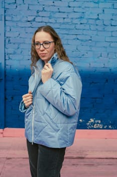 Portrait of a stylish woman in blue jacket. Spring outdoor portrait.