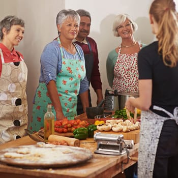 Youre never too old to learn. a group of seniors attending a cooking class