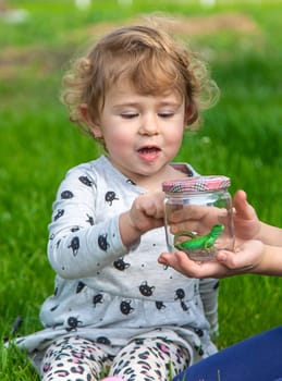 Child in nature with a lizard. Selective focus. Kid.