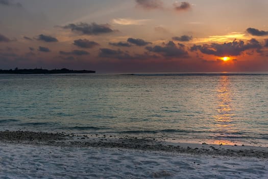 Colorful sunset on an island in the Maldives in the Indian Ocean