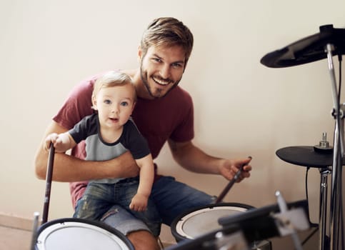 Cool father, baby portrait and drummer musician with music development and child learning. Home, happiness and kid with youth drumming lesson with a smile, love and parent care at a family house.