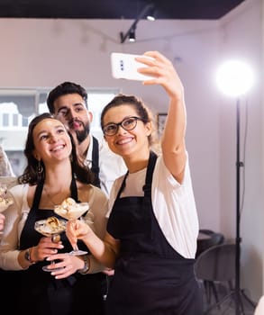 Students in cookery class taking selfie after cooking - friends and social media