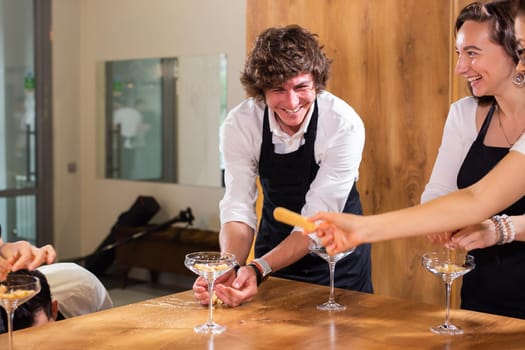 Happy chef and his colleague standing at kitchen and looking at camera - food and restaurant