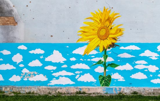 The wall of the kindergarten building, beaten by rocket fragments in the war zone. Shelled wall. Facade of a bombed-out building. Armed conflict in Ukraine. Ukraine, Kyiv - May 06, 2023