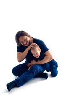 young handsome father with his son fooling around, lifestyle on white background. High quality photo