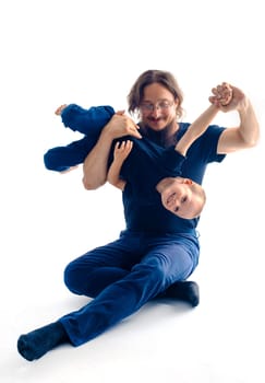 young handsome father with his son fooling around, lifestyle on white background. High quality photo